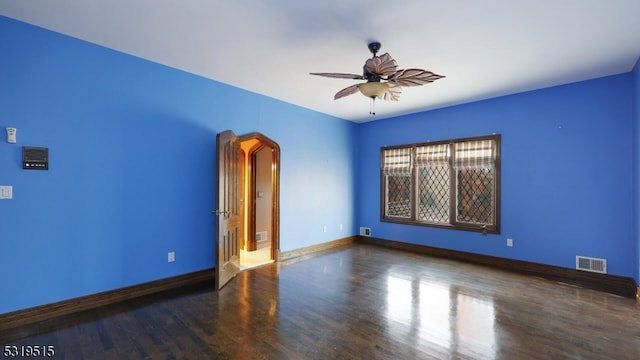 spare room featuring ceiling fan and dark hardwood / wood-style floors