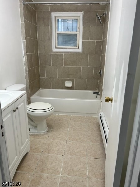 full bathroom with vanity, tiled shower / bath, a baseboard heating unit, and toilet