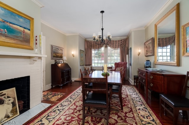 dining space featuring ornamental molding, a chandelier, dark wood-type flooring, and a brick fireplace