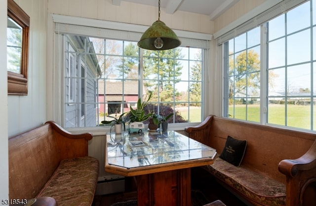 sunroom featuring breakfast area and a wealth of natural light