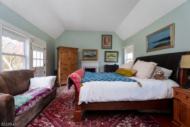 bedroom featuring lofted ceiling and multiple windows