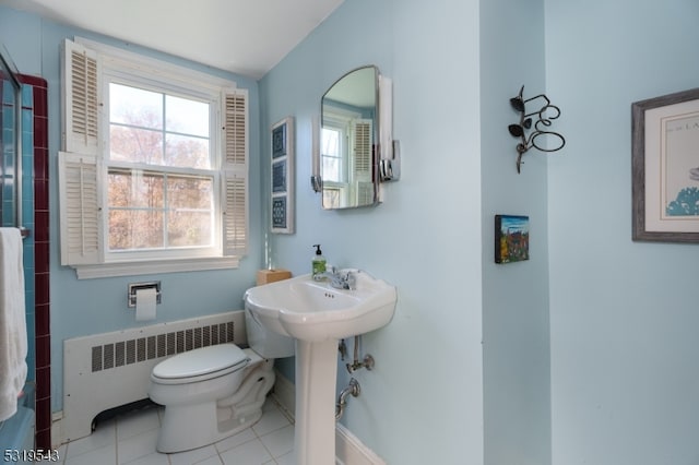 bathroom featuring toilet, tile patterned floors, radiator heating unit, and a shower with shower curtain