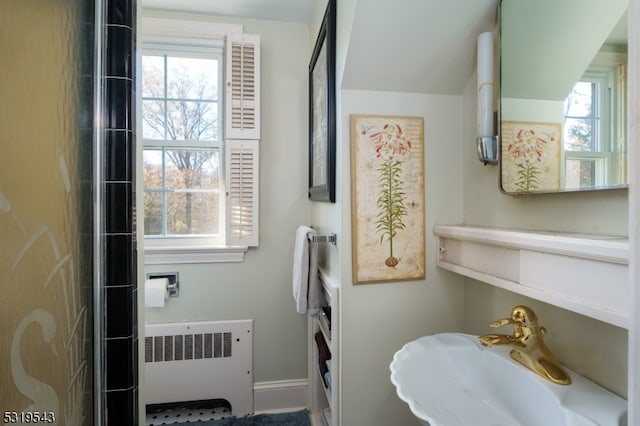 bathroom featuring plenty of natural light, sink, and radiator