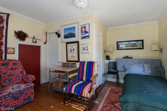 sitting room featuring dark wood-type flooring and crown molding