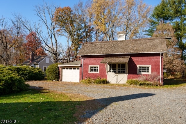 garage featuring a lawn