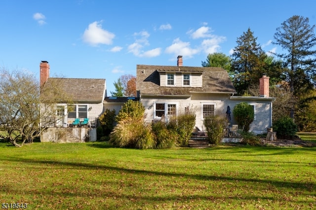 rear view of house with a yard