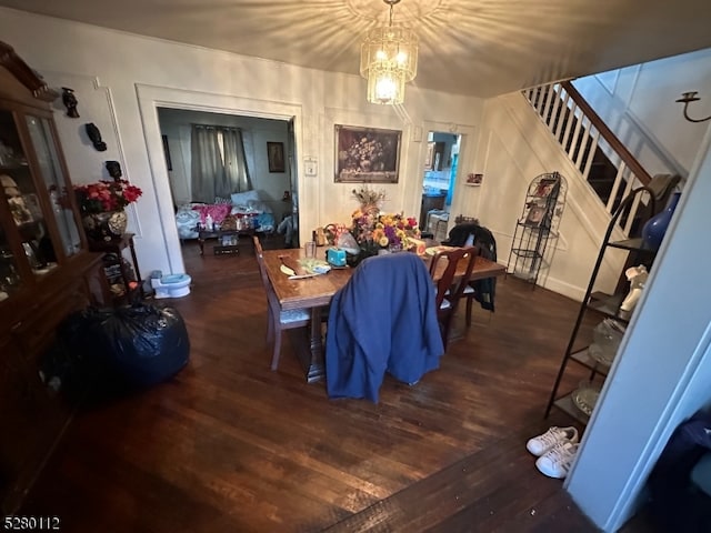 dining space featuring a chandelier and dark hardwood / wood-style floors