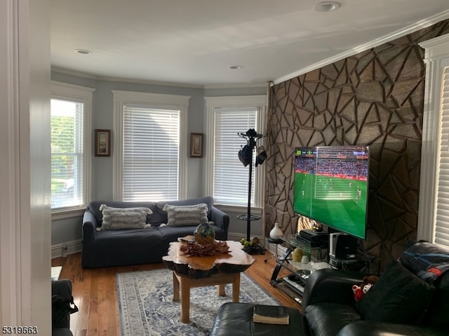 living room with crown molding and hardwood / wood-style floors