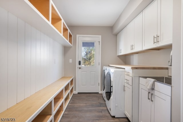 washroom featuring cabinets, washer and dryer, and dark hardwood / wood-style flooring