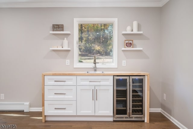 bar featuring baseboard heating, wood counters, wine cooler, sink, and white cabinets