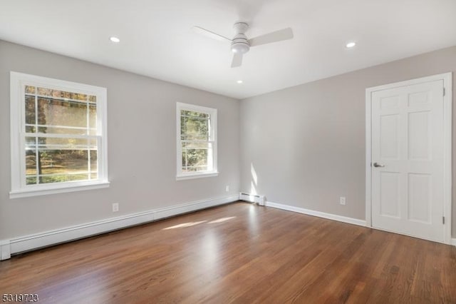 empty room featuring recessed lighting, a ceiling fan, baseboard heating, and wood finished floors