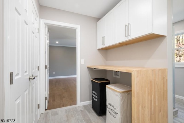 unfurnished office featuring baseboards, recessed lighting, and light wood-style flooring