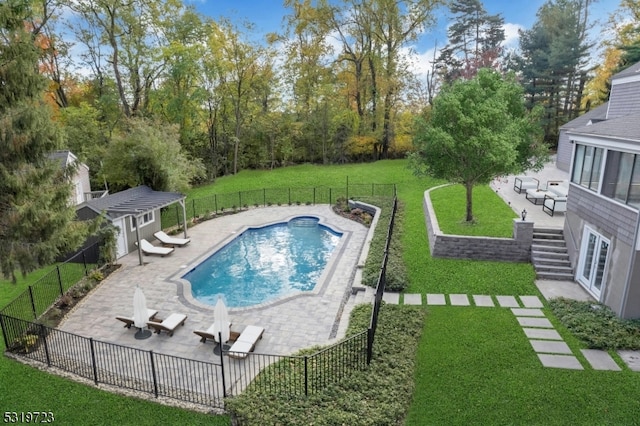 view of pool featuring a patio, a lawn, and an outdoor structure