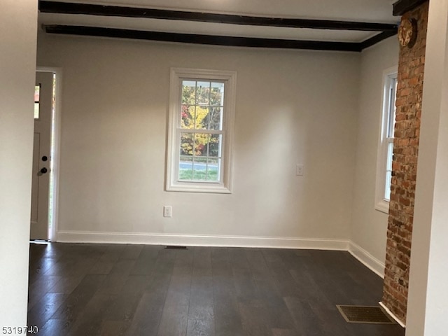 empty room featuring beam ceiling and dark hardwood / wood-style flooring