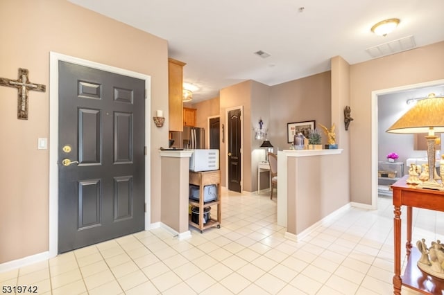 foyer with light tile patterned flooring