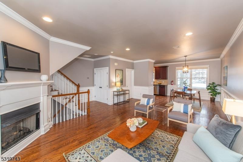 living room with ornamental molding and dark wood-type flooring