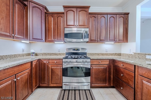 kitchen featuring light stone countertops, crown molding, appliances with stainless steel finishes, and light tile patterned floors