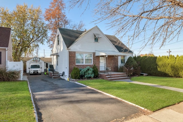 bungalow-style home with an outbuilding, a front lawn, and a garage