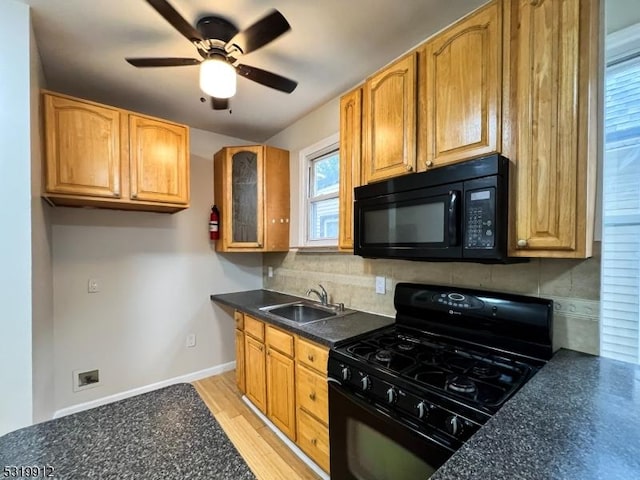 kitchen with black appliances, dark countertops, decorative backsplash, glass insert cabinets, and ceiling fan