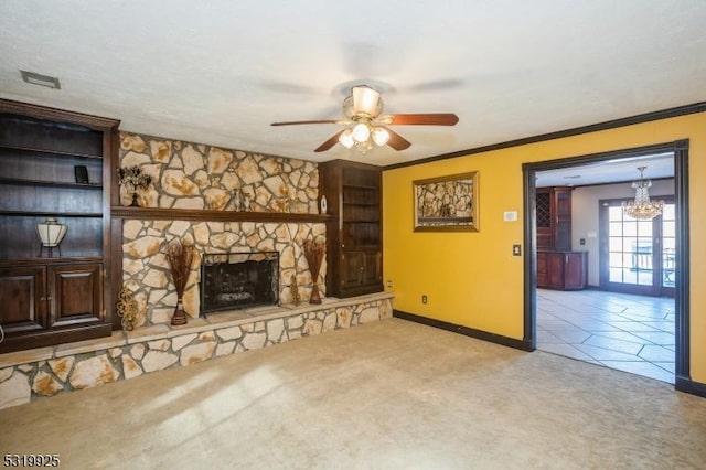 unfurnished living room with a stone fireplace, baseboards, light carpet, and ceiling fan with notable chandelier