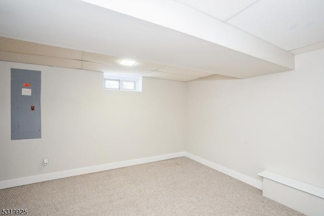 below grade area featuring carpet floors, electric panel, and baseboards