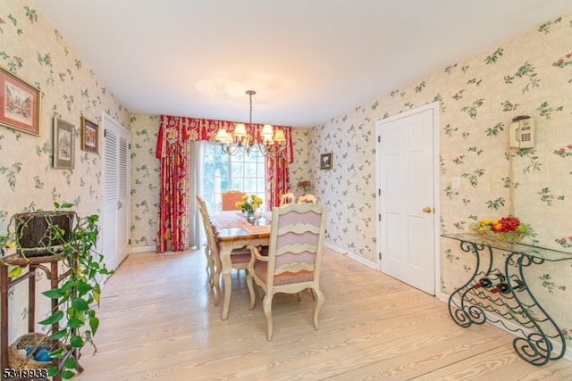 dining space with an inviting chandelier and light wood-type flooring