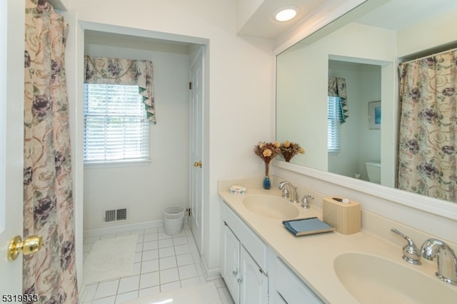 bathroom with vanity, toilet, and tile patterned flooring