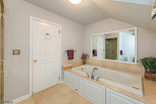 bathroom with toilet, vaulted ceiling, and separate shower and tub