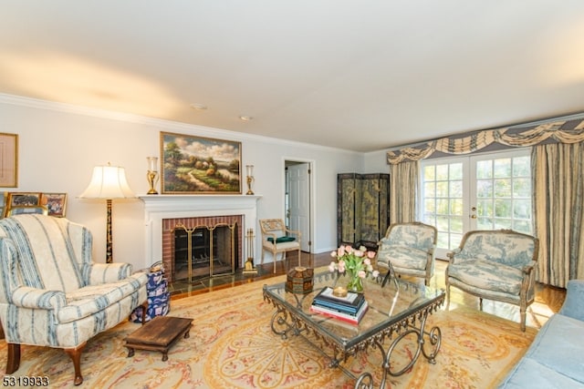 living room featuring light wood-type flooring, ornamental molding, and a brick fireplace