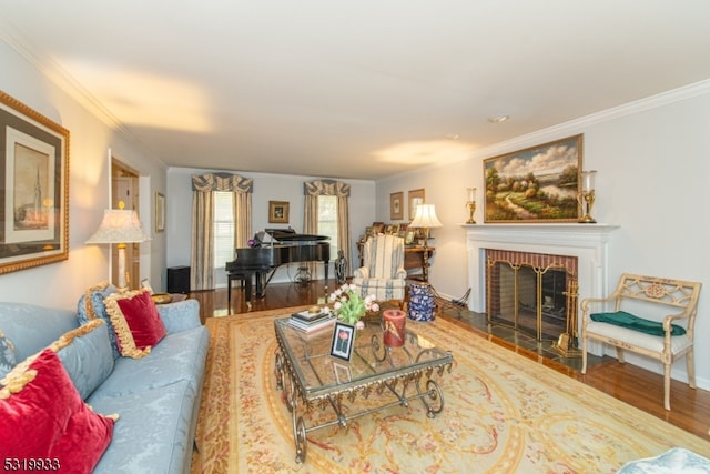 living room with crown molding, hardwood / wood-style floors, and a fireplace