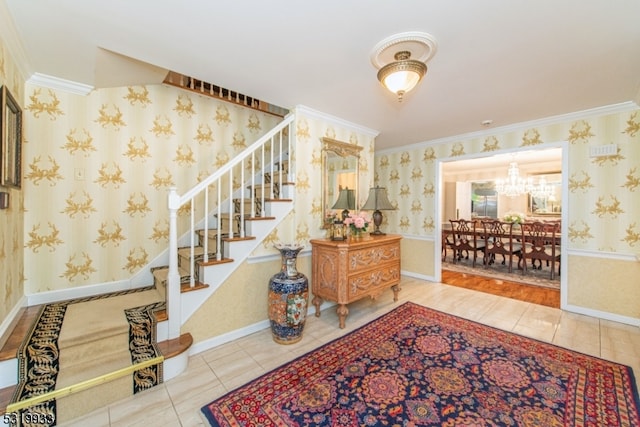 staircase featuring an inviting chandelier, ornamental molding, and tile patterned floors