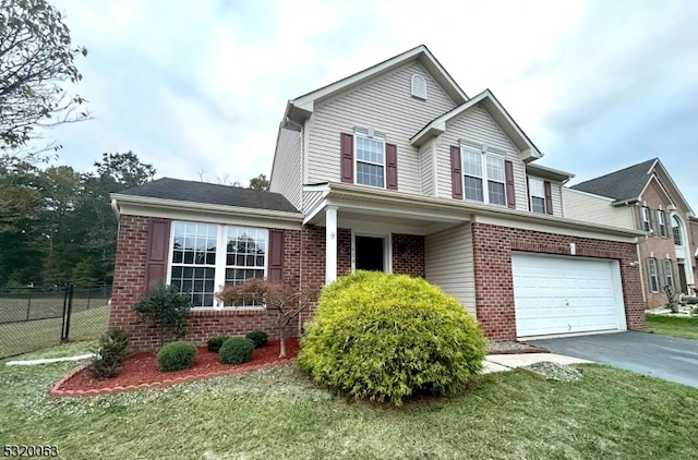 view of front of home with a front yard and a garage