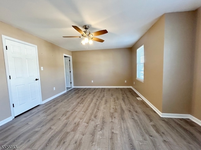 spare room featuring ceiling fan and light wood-type flooring