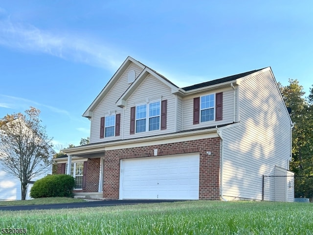 view of front facade with a front yard and a garage