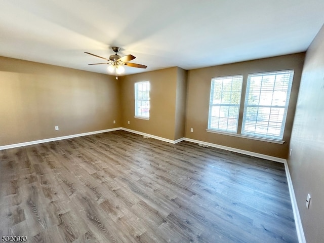 unfurnished room with hardwood / wood-style flooring and ceiling fan