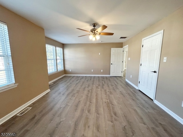 spare room featuring light hardwood / wood-style floors and ceiling fan