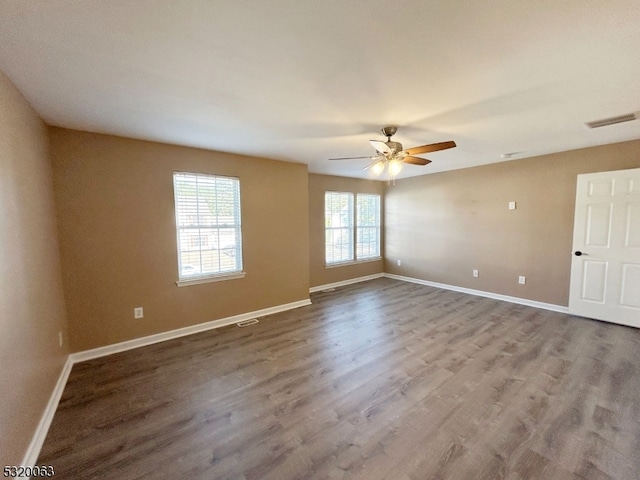 spare room with wood-type flooring and ceiling fan