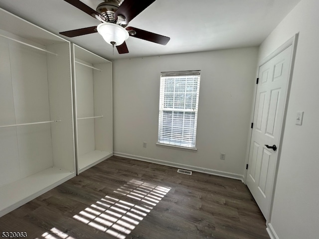 unfurnished bedroom featuring a closet, dark wood-type flooring, and ceiling fan