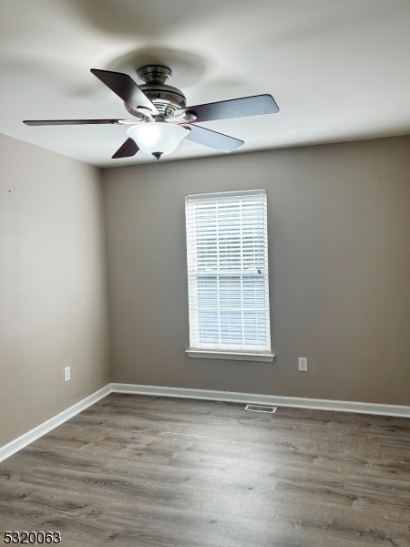 spare room with ceiling fan and hardwood / wood-style flooring