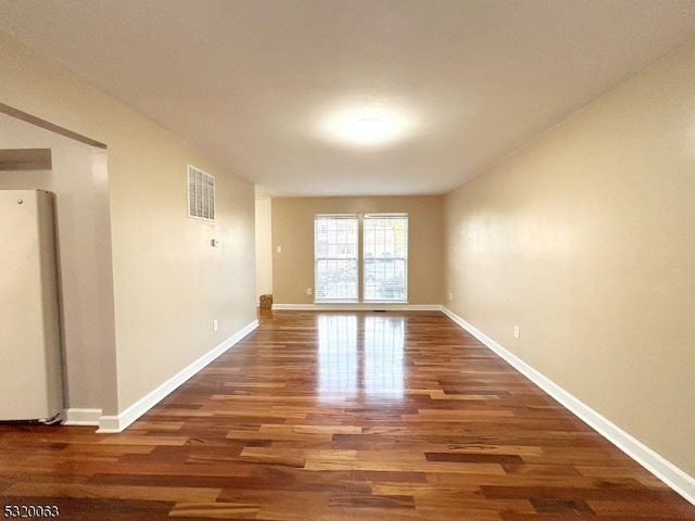 unfurnished room featuring dark wood-type flooring