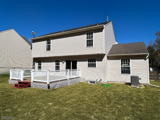 rear view of house with a wooden deck, a lawn, and central AC unit