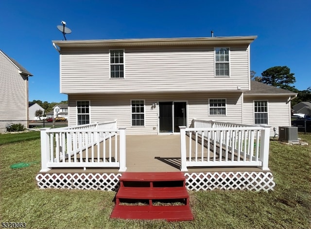 rear view of property featuring a wooden deck, a yard, and central AC unit