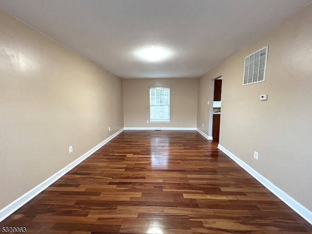 empty room with dark hardwood / wood-style floors