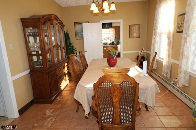 dining space featuring a baseboard radiator, a notable chandelier, a textured ceiling, and light tile patterned floors