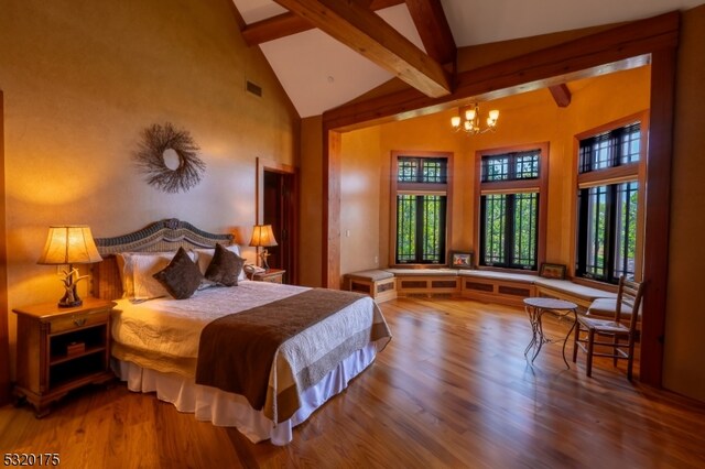 bedroom featuring a notable chandelier, beam ceiling, high vaulted ceiling, and wood-type flooring