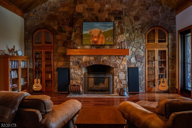 living room with high vaulted ceiling, hardwood / wood-style flooring, wooden ceiling, and a fireplace