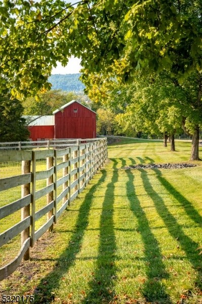 view of yard featuring a rural view and an outdoor structure