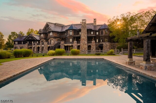 view of pool at dusk