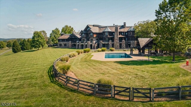 view of property's community with a patio, a lawn, and a pool