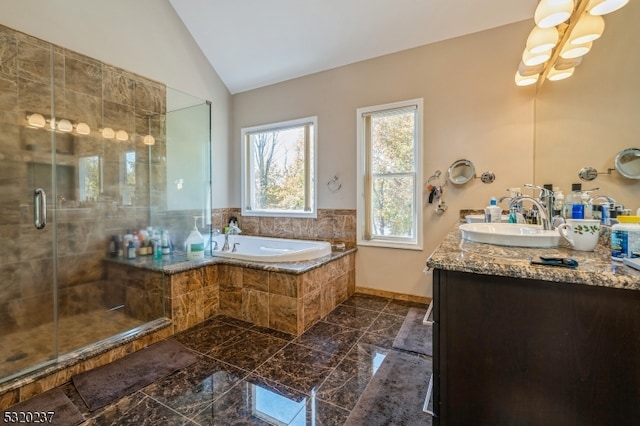 bathroom featuring vaulted ceiling, shower with separate bathtub, and vanity